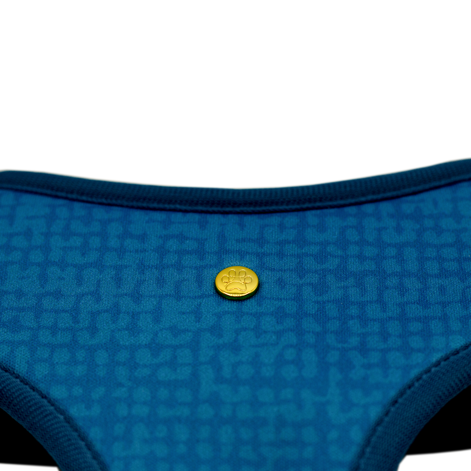 Pata Paw boops reversible harness showing a close-up of its golden paw and timeless and chic texture pattern in aegean blue.