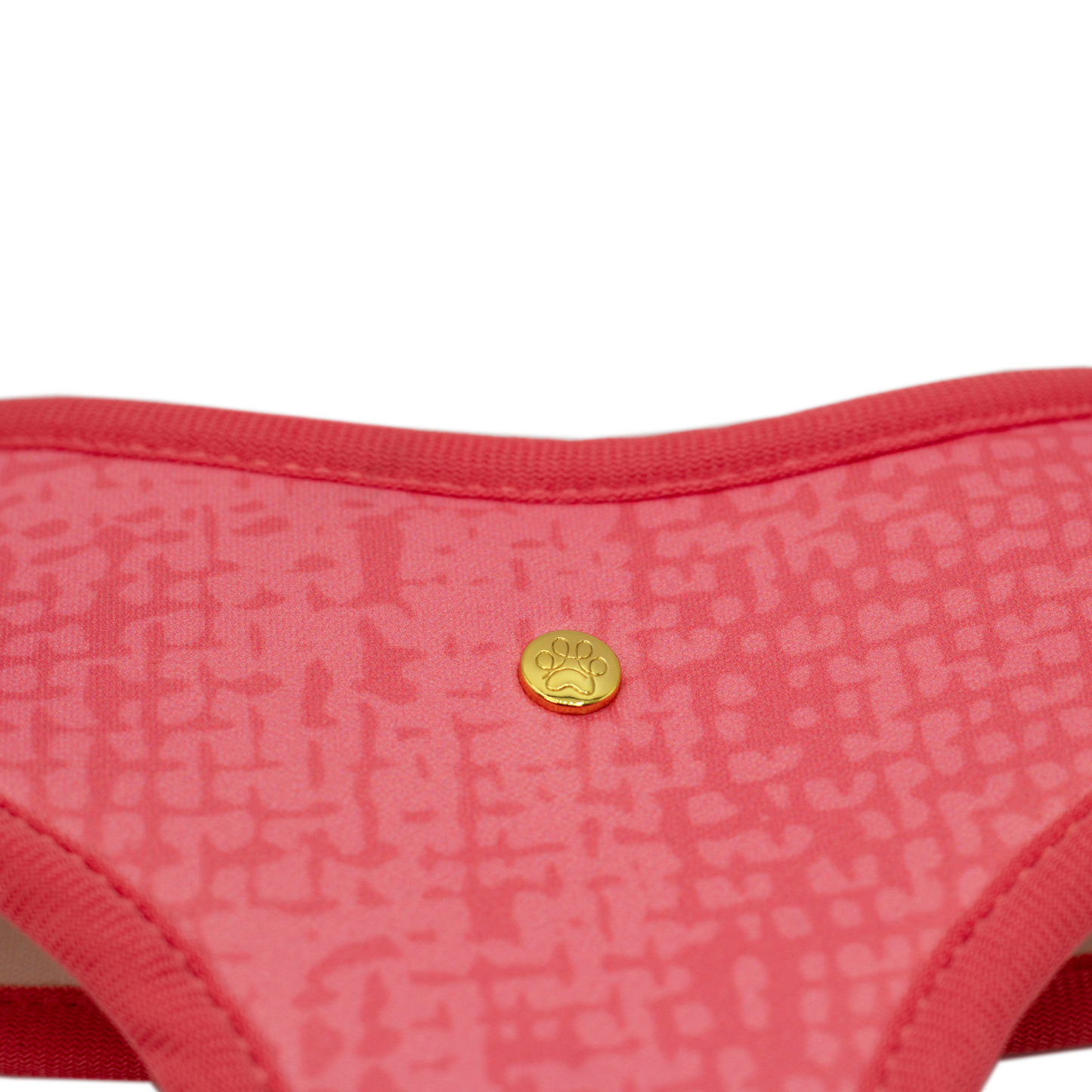 Pata Paw blush hearts reversible harness showing a close-up of its golden paw and a timeless and chic texture pattern in blush.