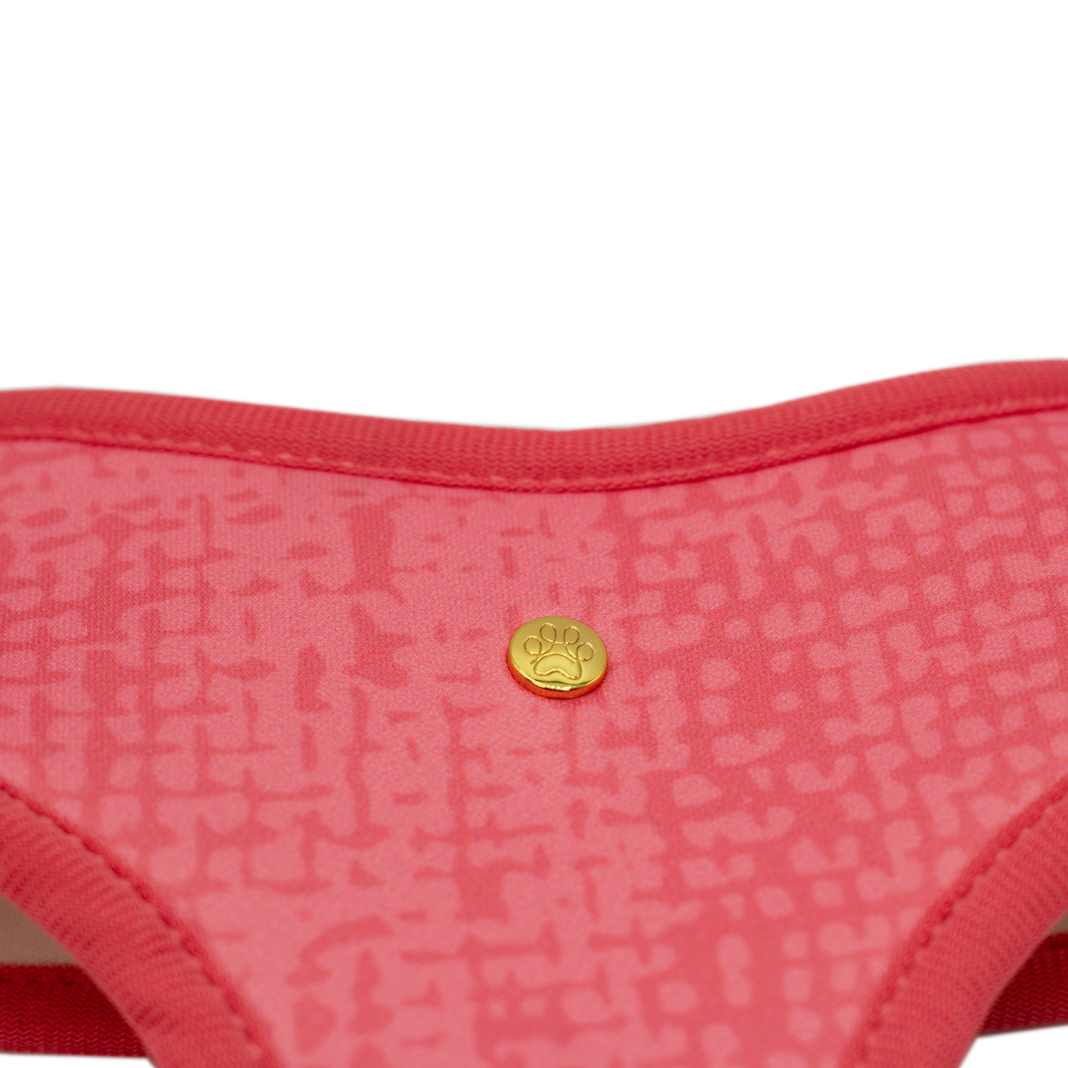 Pata Paw blush hearts reversible harness showing a close-up of its golden paw and a timeless and chic texture pattern in blush.