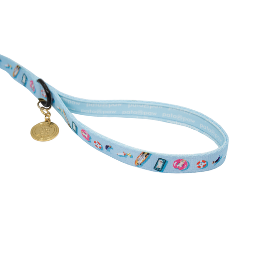 pata paw pool pups showing signature handle, metallic ring to attach a poop bag holder and golden paw medal