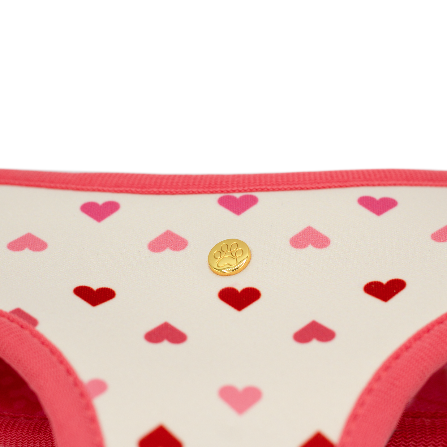 Pata Paw blush hearts reversible harness showing a close-up of its golden paw.