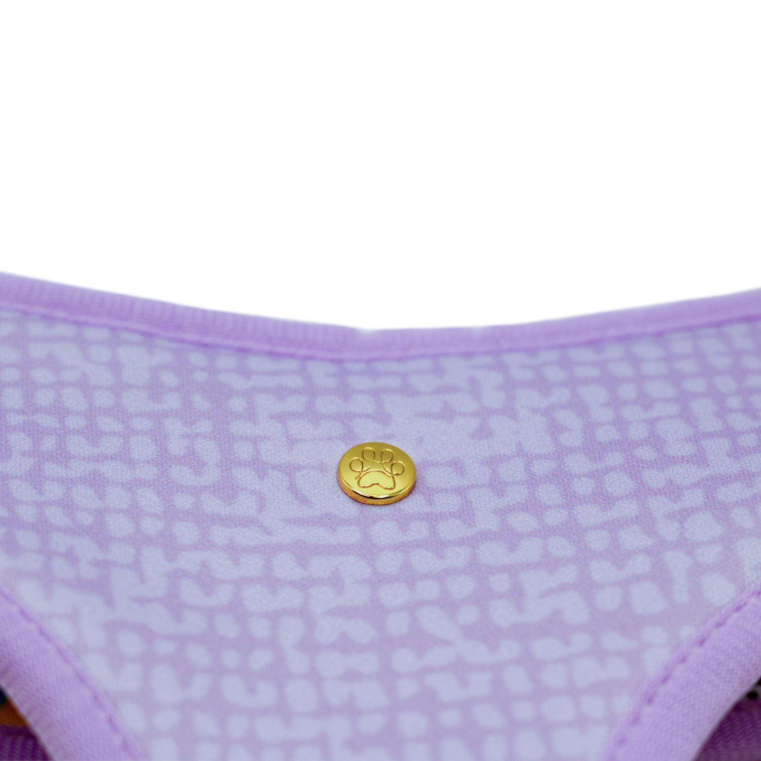Pata Paw toucan tropics reversible harness showing a close-up of its golden paw and a timeless and chic texture pattern in lilac.